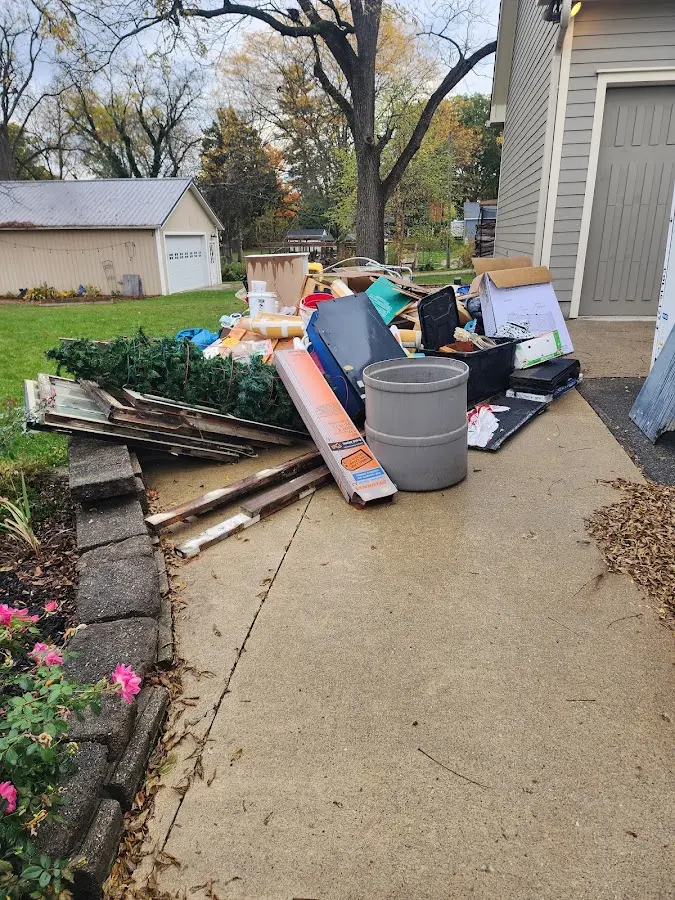 Dumpster being loaded with debris for Commercial Dumpster Rental in Chelmsford